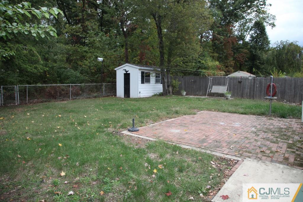 47 Caldwell Road Edison, NJ 08817 - Photo 10 of 14 a backyard of a house with plants and large trees