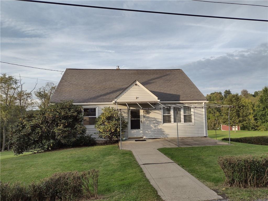 a front view of house with yard and green space