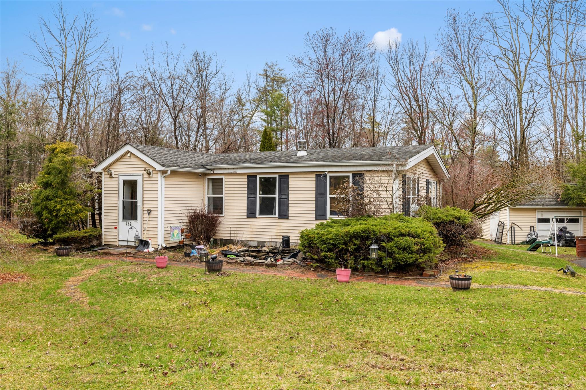 a front view of house with yard and trees