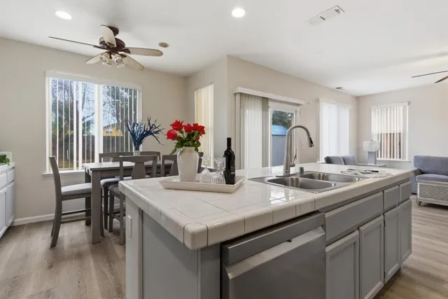 a kitchen with sink refrigerator and dining table