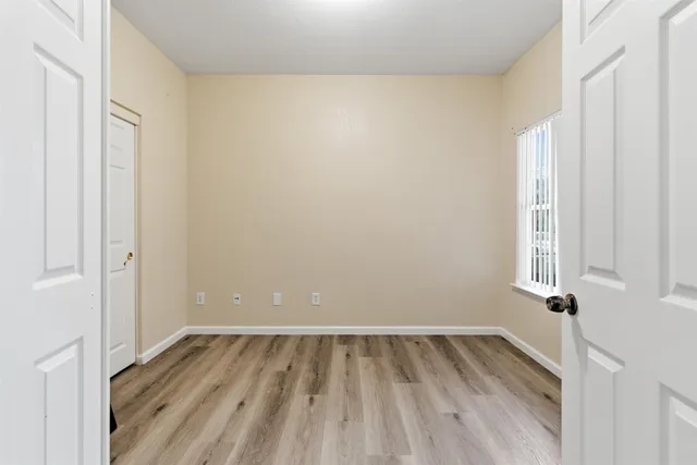a view of a room with wooden floor and small space