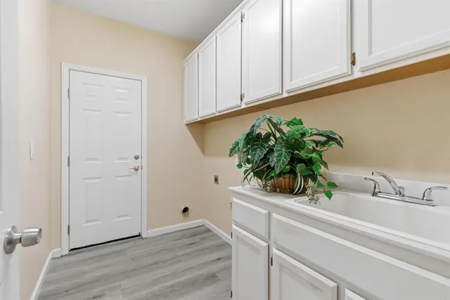a bathroom with a potted plant on the wall