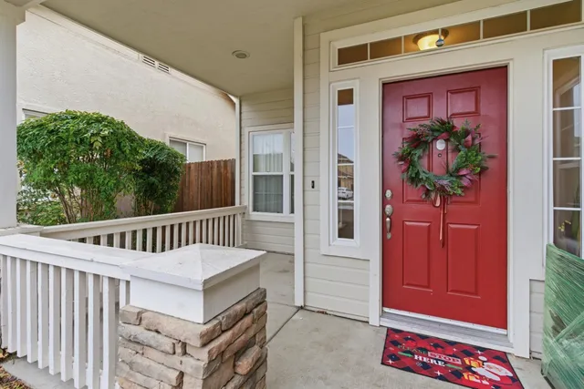 a view of a porch with a table and chairs