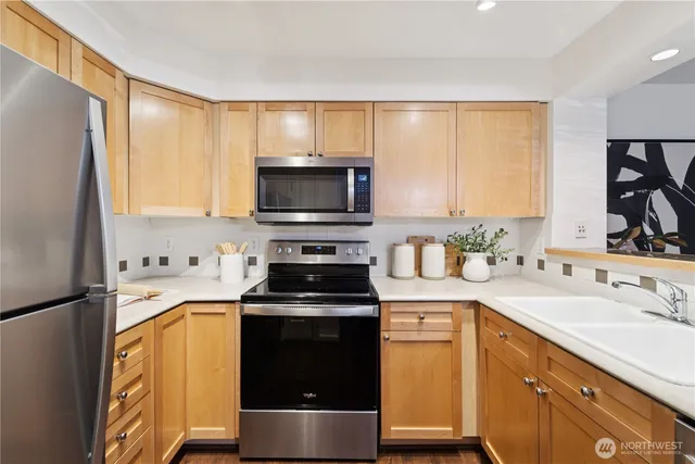 a kitchen with a sink appliances and cabinets