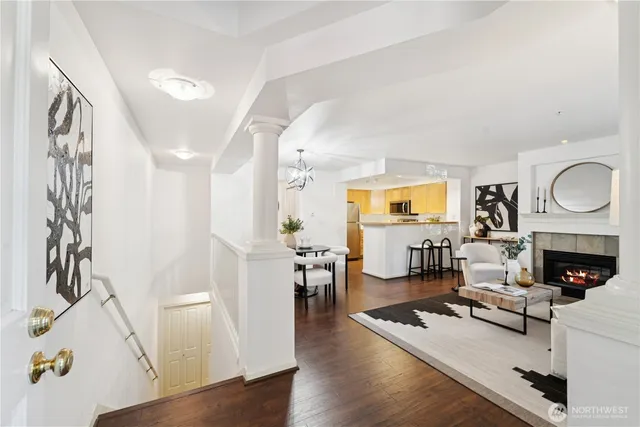 a living room with furniture fireplace and wooden floor