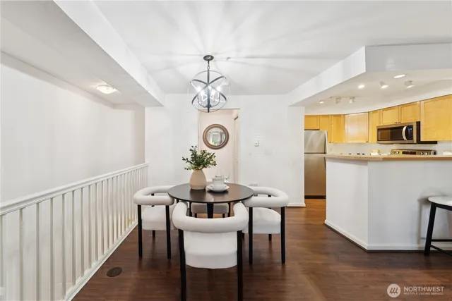 a view of a dining room with furniture a chandelier and wooden floor