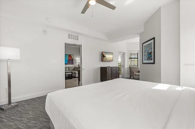 a bedroom with a large bed couch and a window