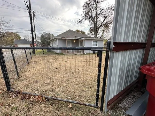 a front view of a house with wooden fence