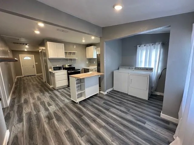 a kitchen with stainless steel appliances a stove top oven a sink and a refrigerator