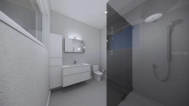 a bathroom with a sink a toilet and shower