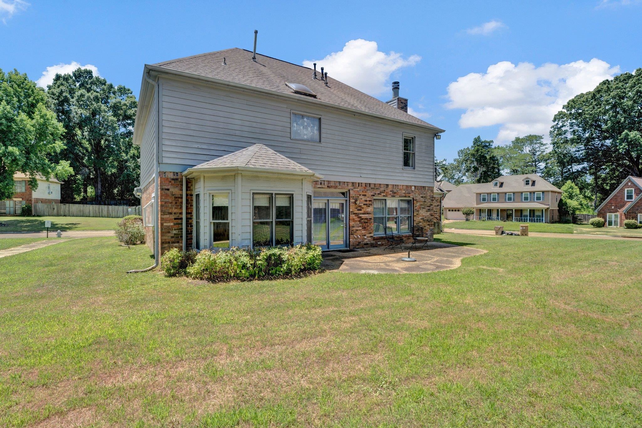 4149 Old Forest Road Memphis, TN 38125 - Photo 4 of 32 Back of house with a lawn