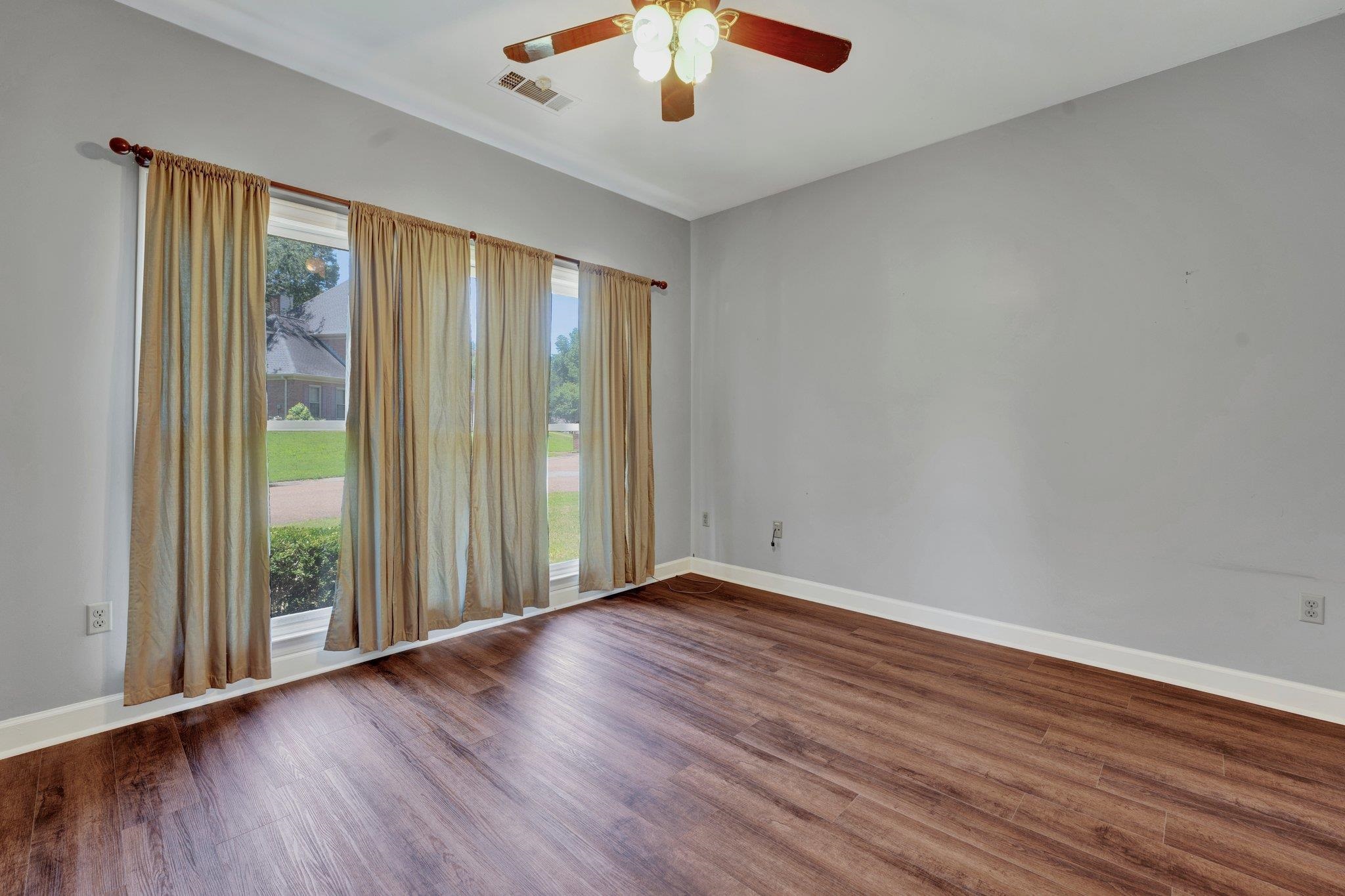 4149 Old Forest Road Memphis, TN 38125 - Photo 9 of 32 Spare room with ceiling fan and dark hardwood / wood-style floors