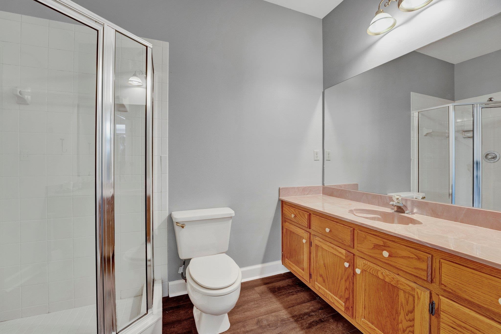 4149 Old Forest Road Memphis, TN 38125 - Photo 10 of 32 Bathroom with a shower with door, hardwood / wood-style flooring, toilet, and vanity