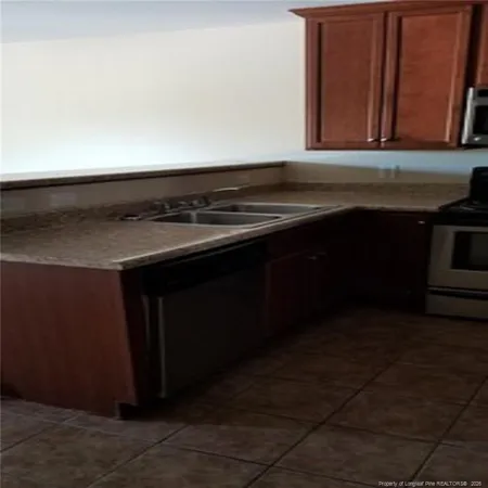 a stove top oven sitting inside of a kitchen