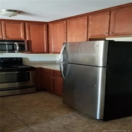a kitchen with a refrigerator and a sink