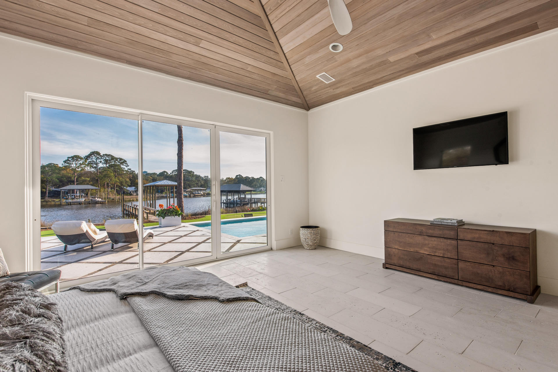 336 East Shipwreck Road Santa Rosa Beach, FL 32459 - Photo 42 of 73 a living room with furniture a flat screen tv and a floor to ceiling window