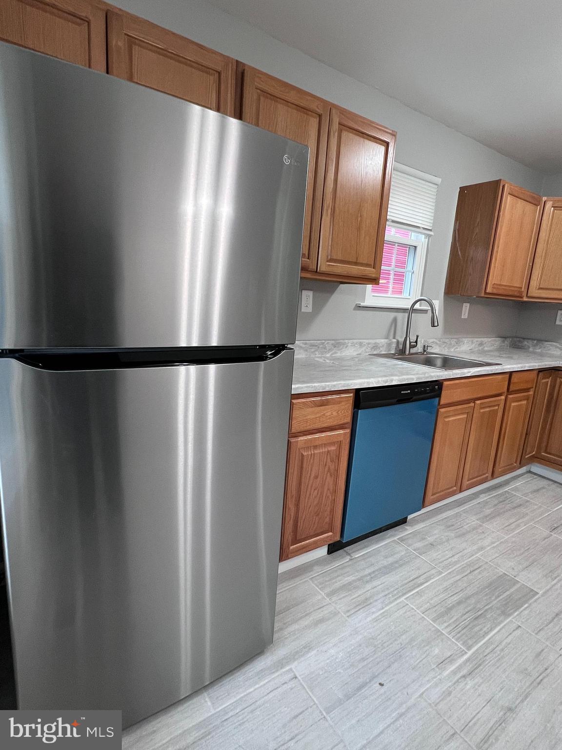 114 Gloucester Avenue Lawnside, NJ 08045 - Photo 19 of 22 a kitchen with stainless steel appliances granite countertop a refrigerator a sink and dishwasher