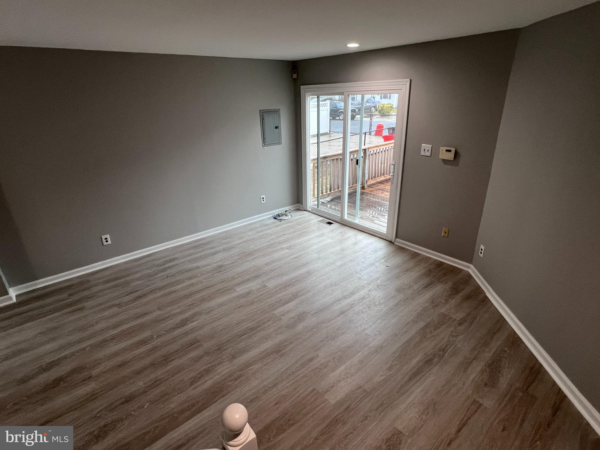 114 Gloucester Avenue Lawnside, NJ 08045 - Photo 4 of 22 wooden floor in an empty room with a window