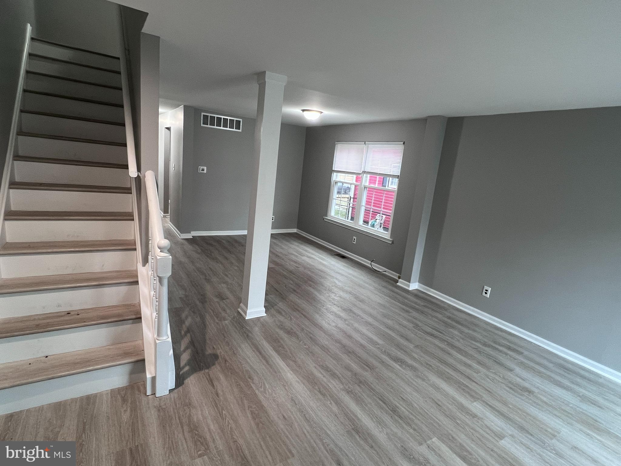 114 Gloucester Avenue Lawnside, NJ 08045 - Photo 6 of 22 wooden floor in an empty room with a window