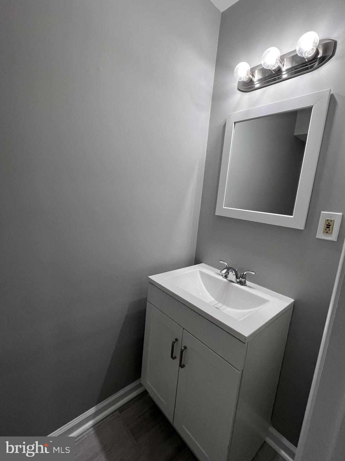 114 Gloucester Avenue Lawnside, NJ 08045 - Photo 7 of 22 a bathroom with a sink and a mirror
