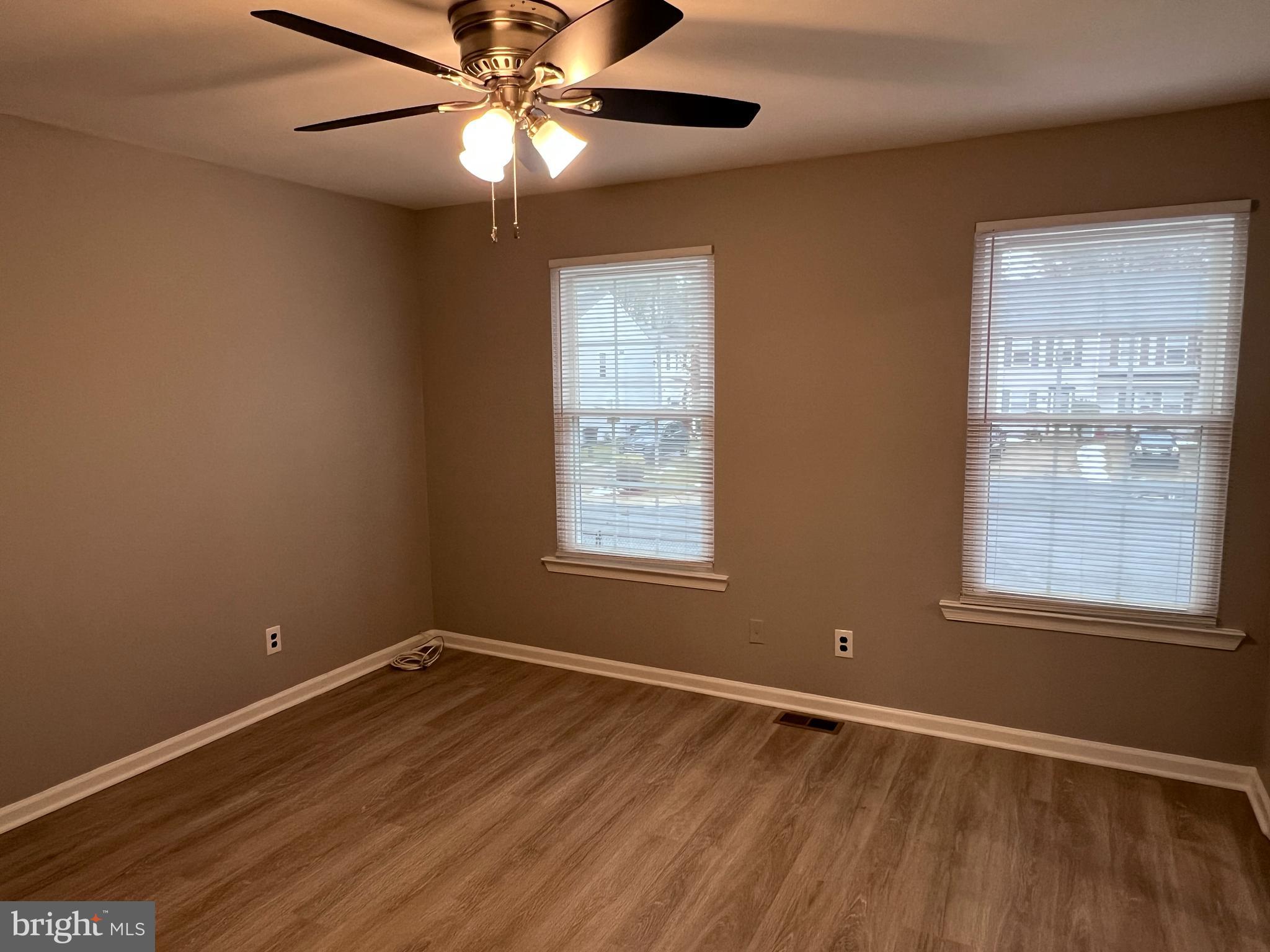 114 Gloucester Avenue Lawnside, NJ 08045 - Photo 10 of 22 a view of an empty room with wooden floor and a window