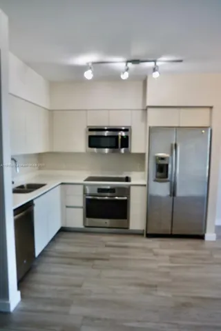 a kitchen with a stove and a microwave