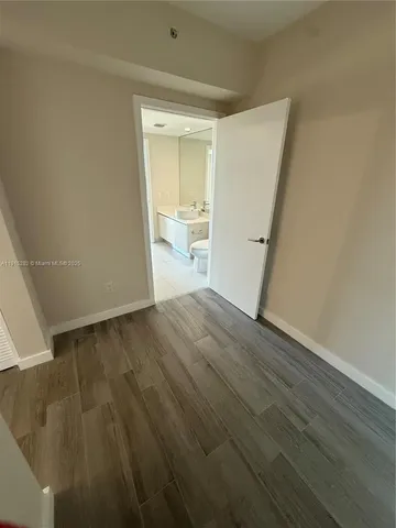 a view of a room with wooden floor and a sink