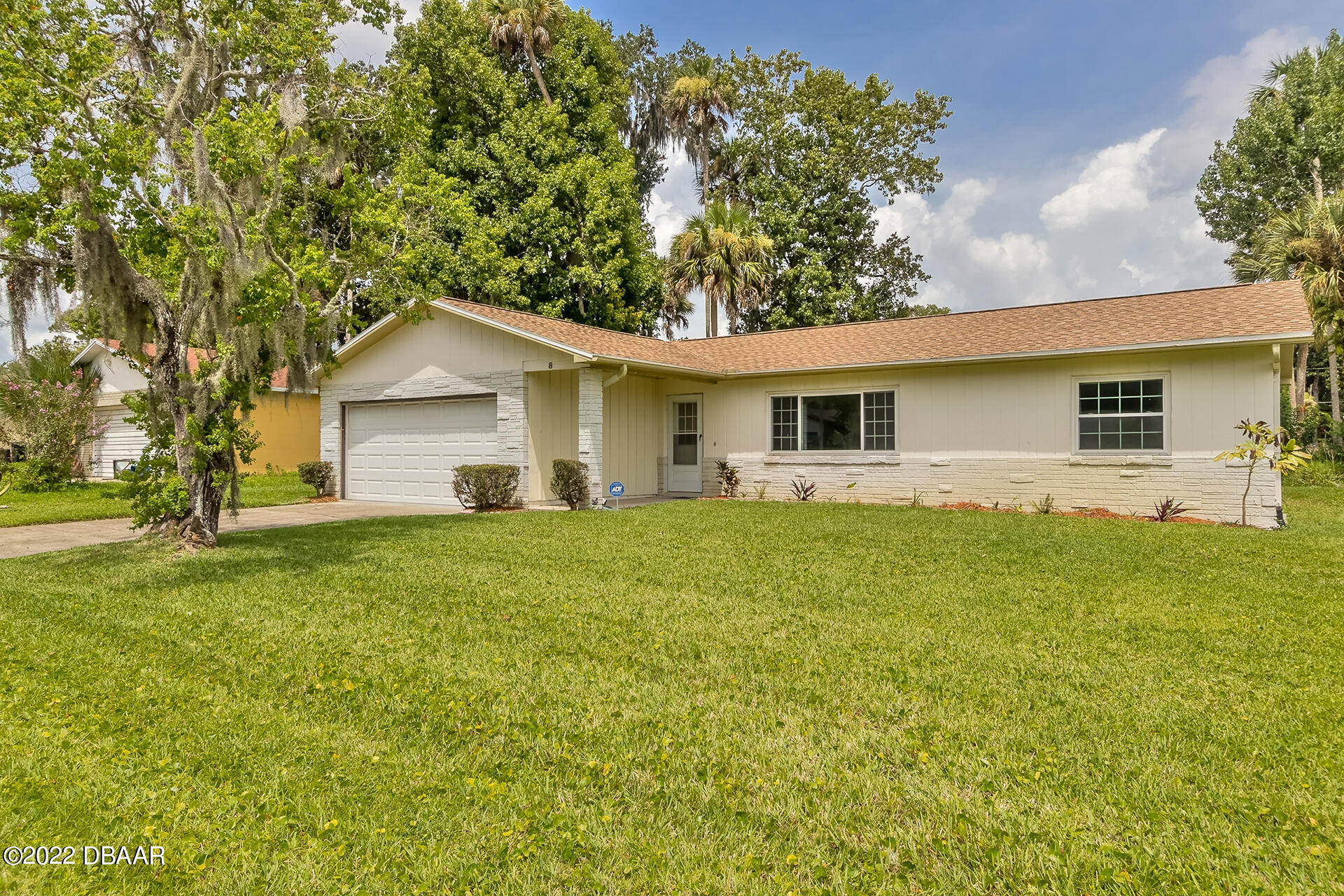 a front view of house with yard and green space