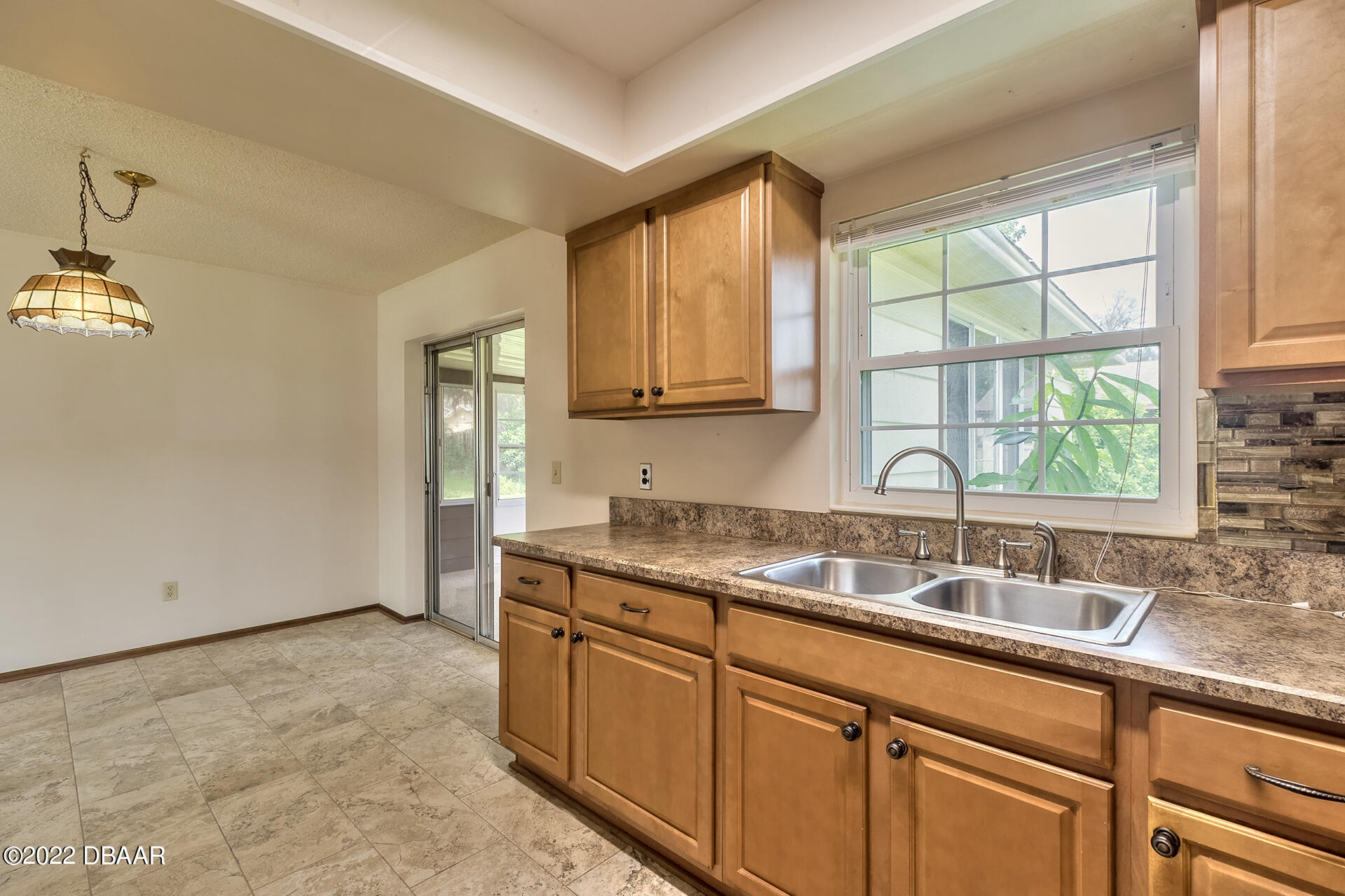 8 Greenfern Circle Ormond Beach, FL 32174 - Photo 11 of 25 a kitchen with a sink cabinets and window