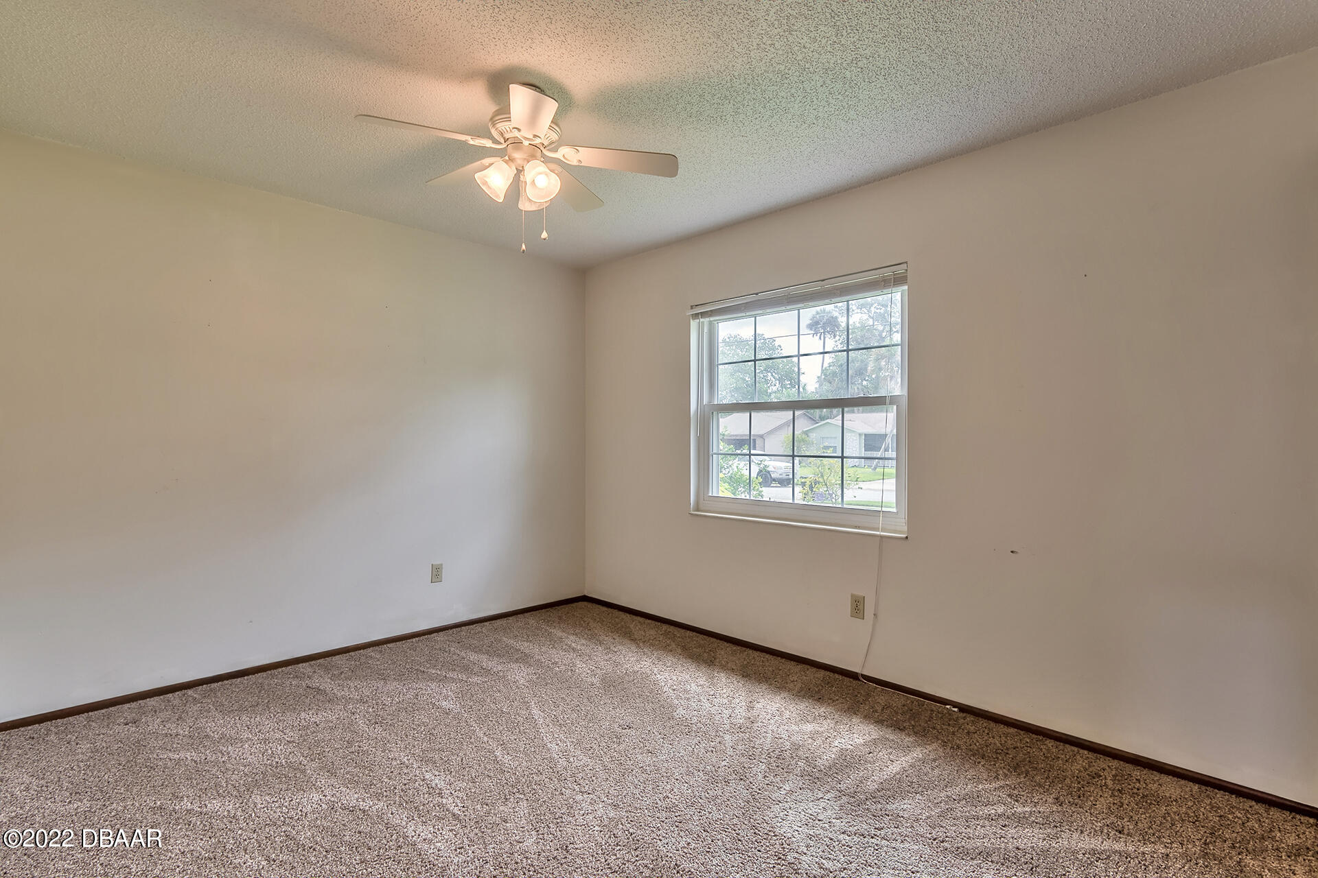 8 Greenfern Circle Ormond Beach, FL 32174 - Photo 15 of 25 an empty room with a window and a fan