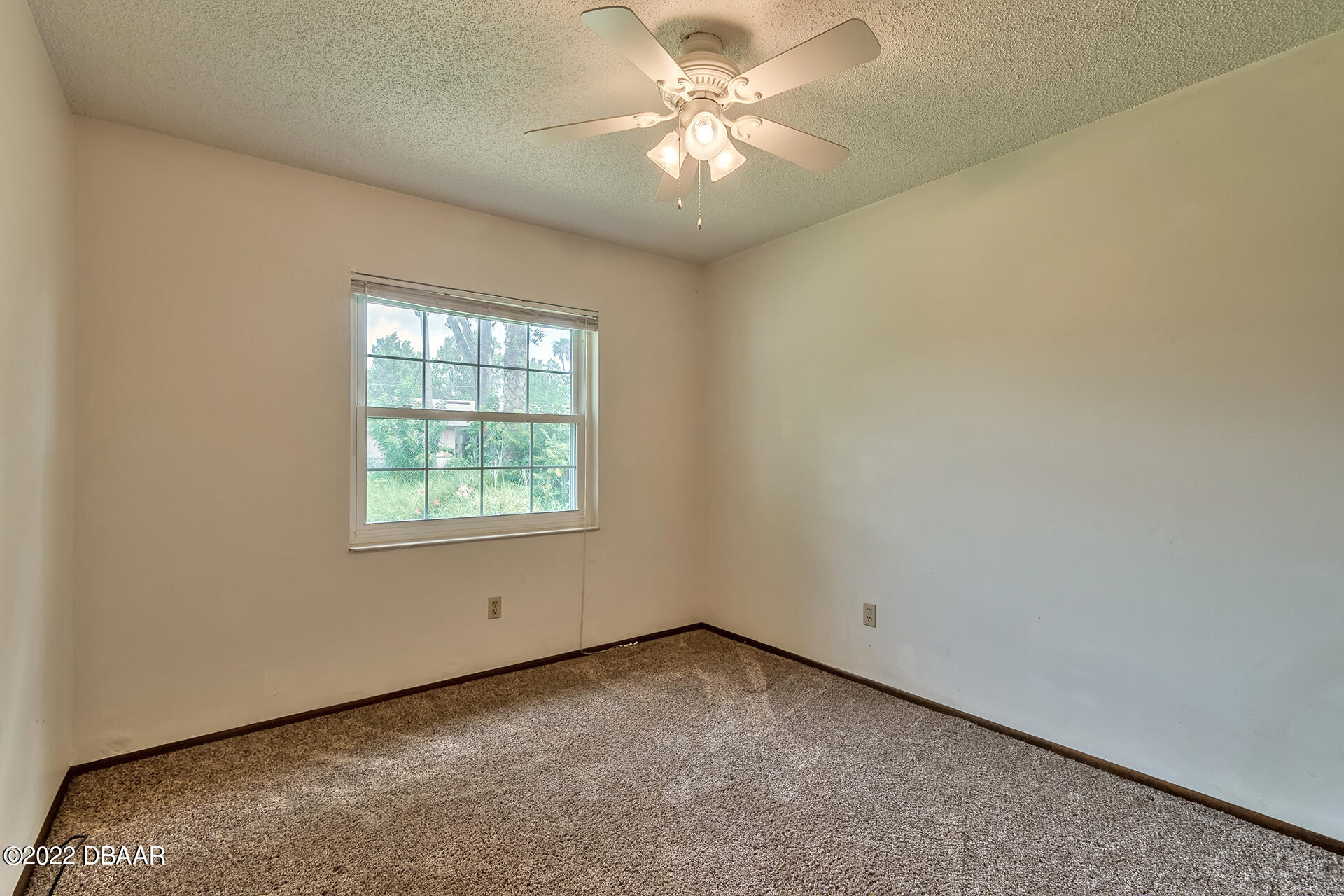 8 Greenfern Circle Ormond Beach, FL 32174 - Photo 18 of 25 an empty room with a window and a fan