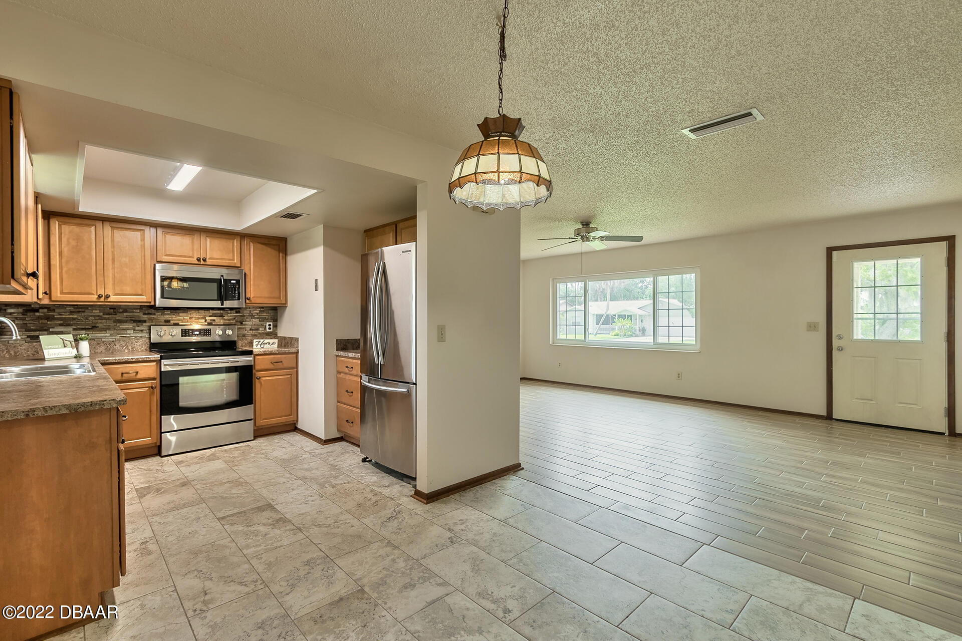 8 Greenfern Circle Ormond Beach, FL 32174 - Photo 25 of 25 a view of a kitchen with a sink stove cabinets and empty room