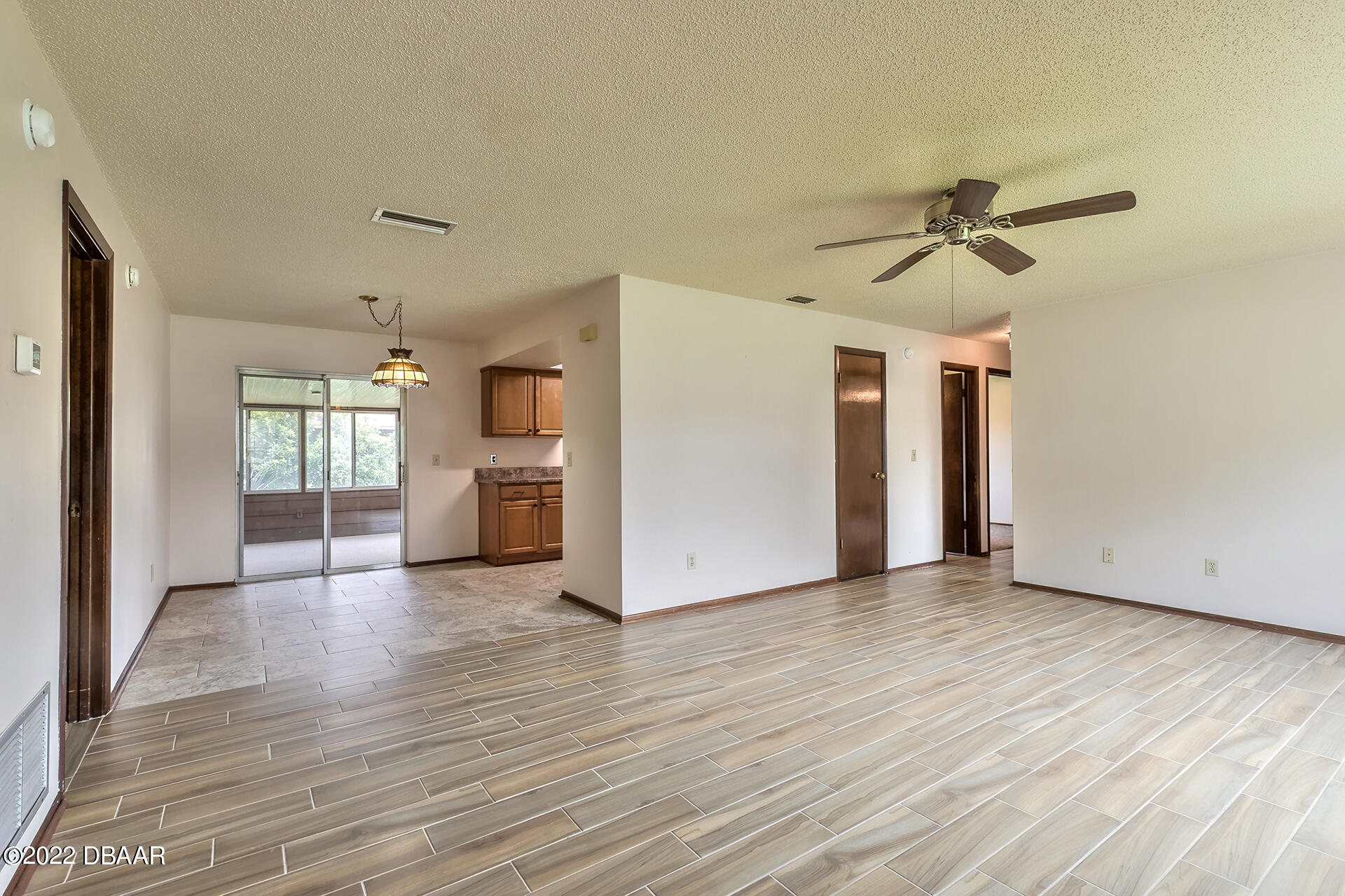 8 Greenfern Circle Ormond Beach, FL 32174 - Photo 5 of 25 a view of empty room with wooden floor and ceiling fan