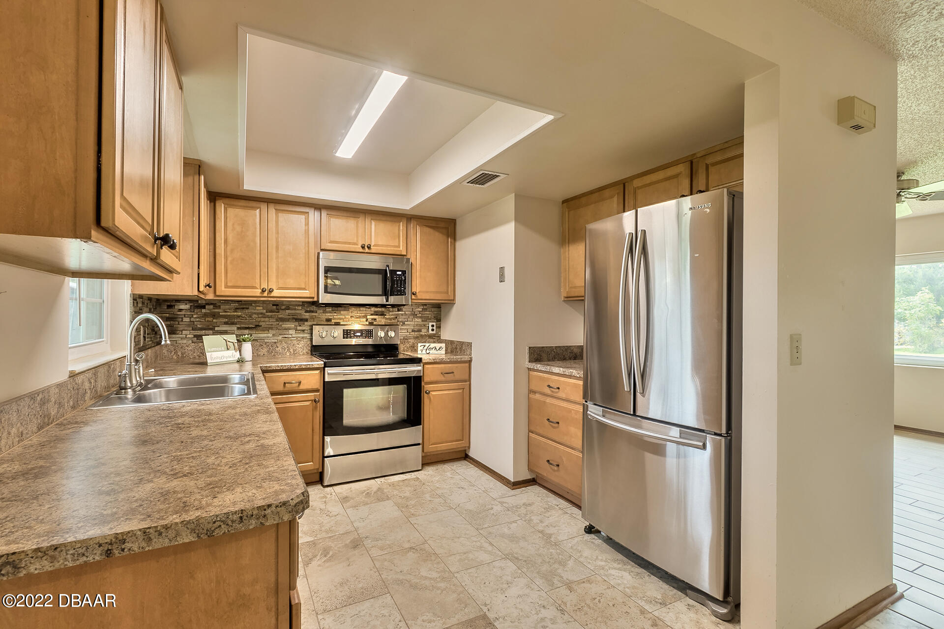 8 Greenfern Circle Ormond Beach, FL 32174 - Photo 9 of 25 a kitchen with granite countertop a refrigerator and a sink
