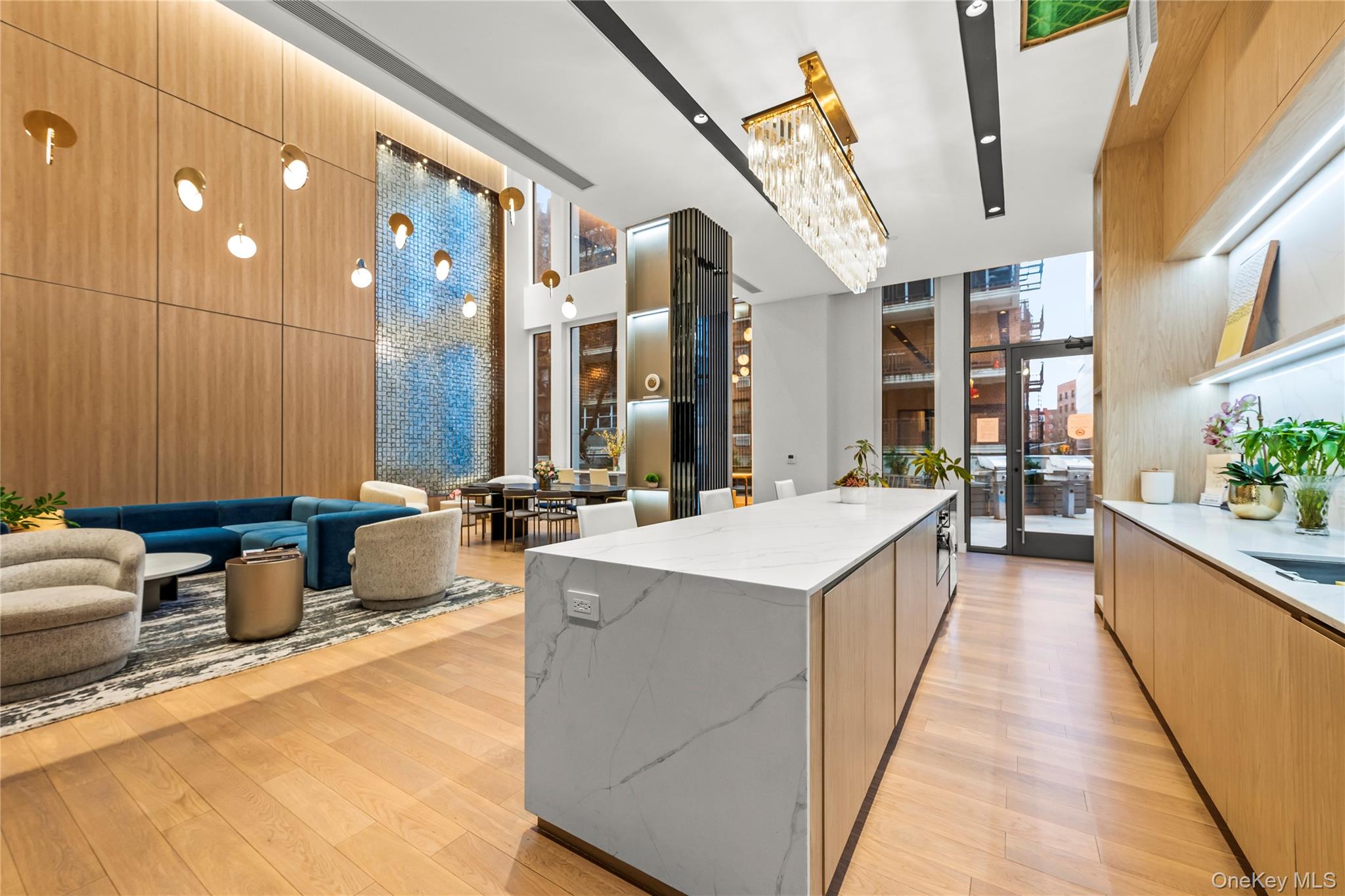 13618 Maple Avenue, Unit 5F Queens, NY 11355 - Photo 16 of 41 Kitchen with modern cabinets, light stone countertops, a spacious island, light brown cabinetry, and a chandelier