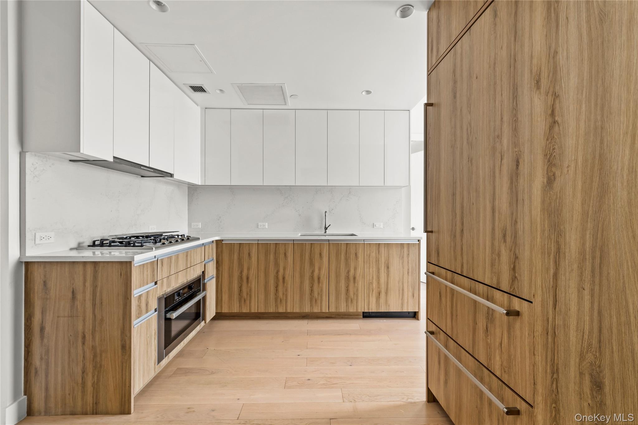 13618 Maple Avenue, Unit 5F Queens, NY 11355 - Photo 8 of 41 Kitchen featuring modern cabinets, brown cabinetry, white cabinets, and light wood-style flooring