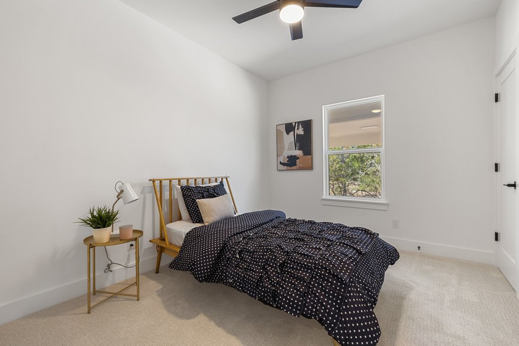 408 Rust Ranch Road Blanco, TX 78606 - Photo 21 of 35 Bedroom featuring light colored carpet and ceiling fan