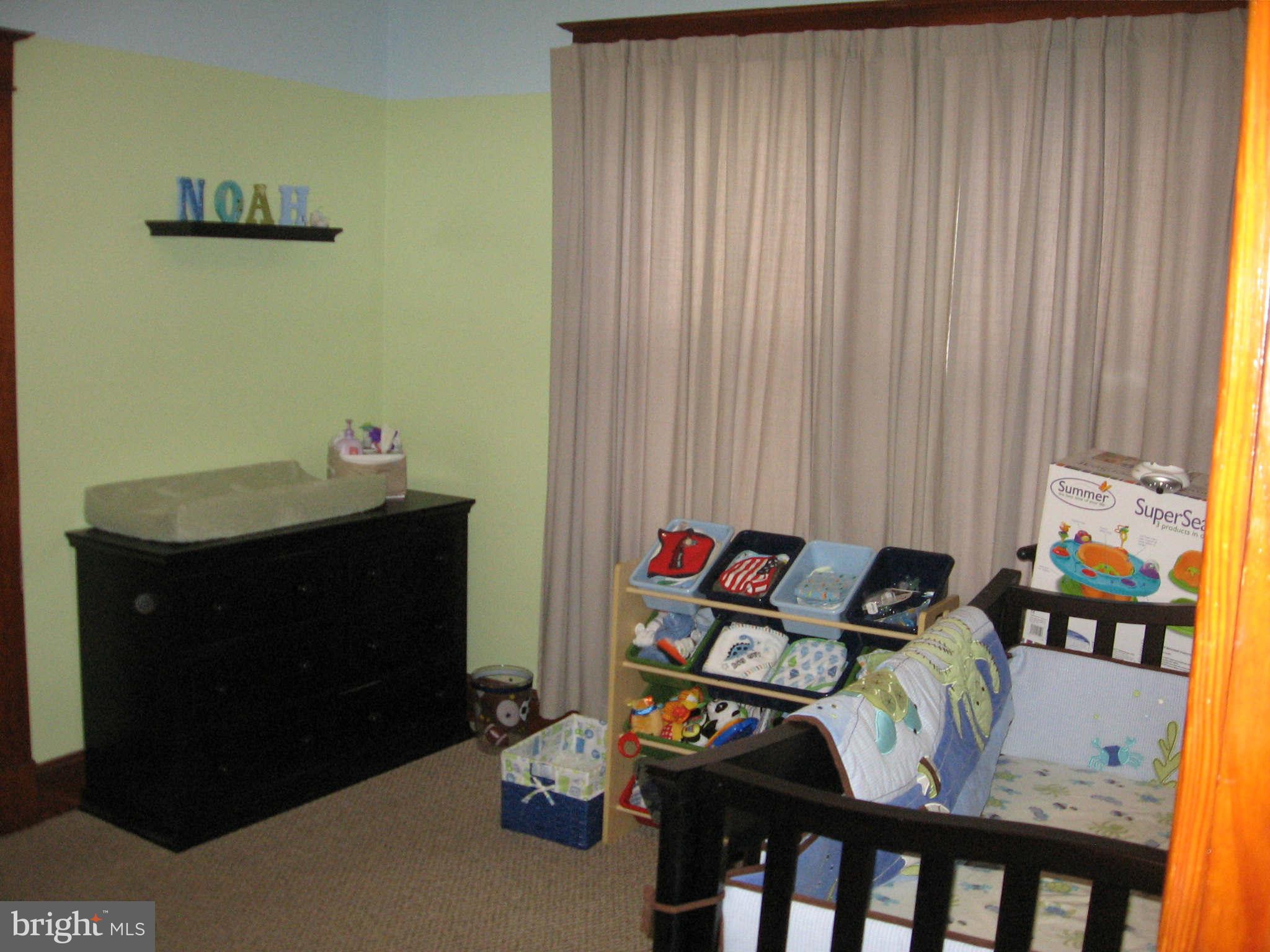 6604 North Point Road Baltimore, MD 21219 - Photo 22 of 22 a bedroom with a bed and furniture