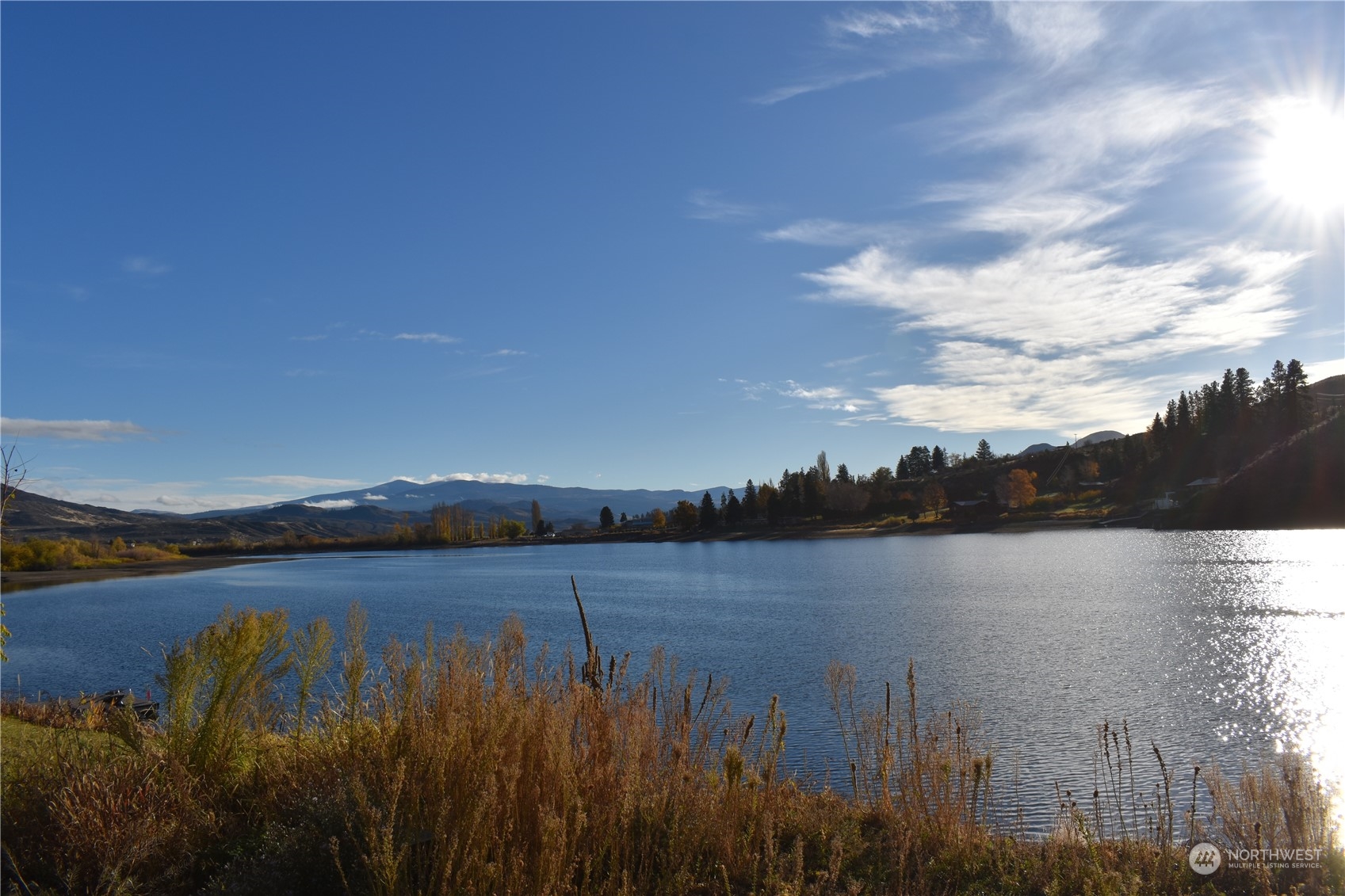 685 Loomis-Oroville Road Tonasket, WA 98855 - Photo 11 of 36 a view of a lake with houses in the back