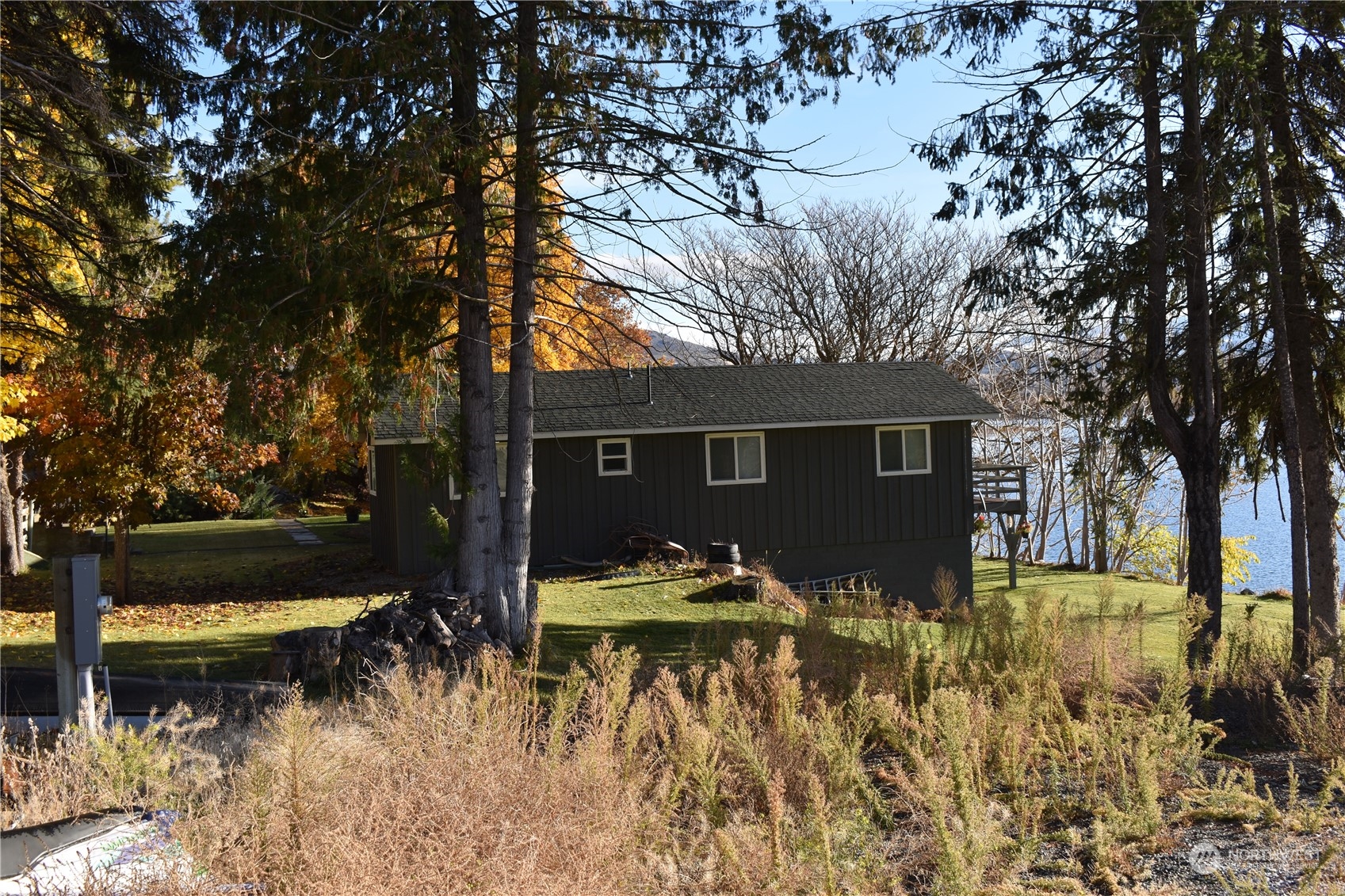685 Loomis-Oroville Road Tonasket, WA 98855 - Photo 35 of 36 a view of house with yard and covered with tall trees