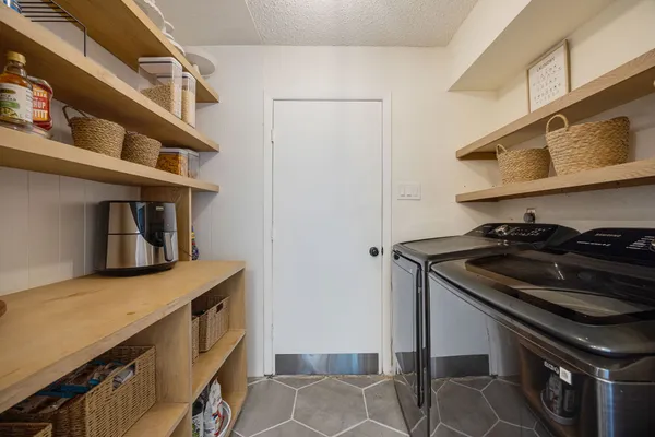 a kitchen with stainless steel appliances granite countertop a sink and a stove