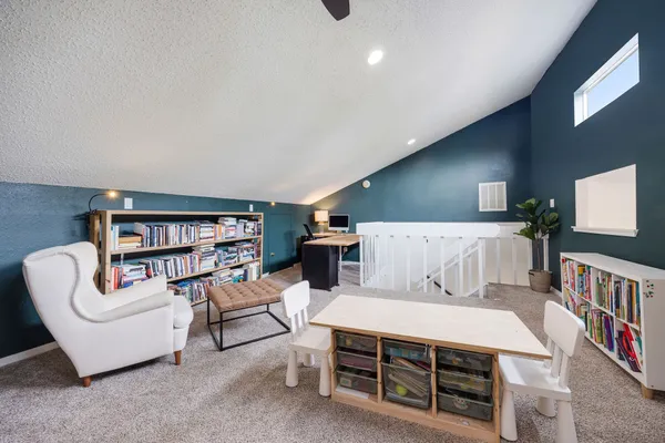 a living room with furniture and a book shelf