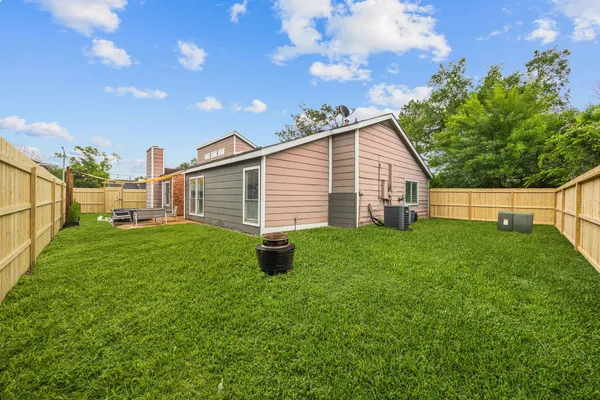 a view of a backyard with plants and a garden