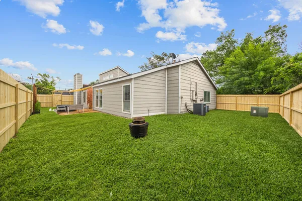 a view of a backyard with plants and a garden