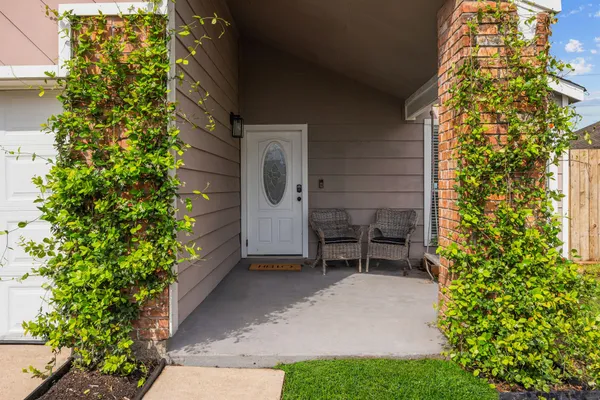 a view of a patio with table and chairs and potted plants