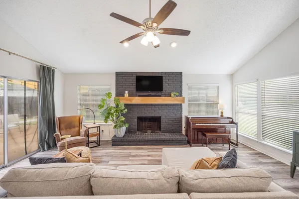 a living room with furniture a fireplace and a flat screen tv