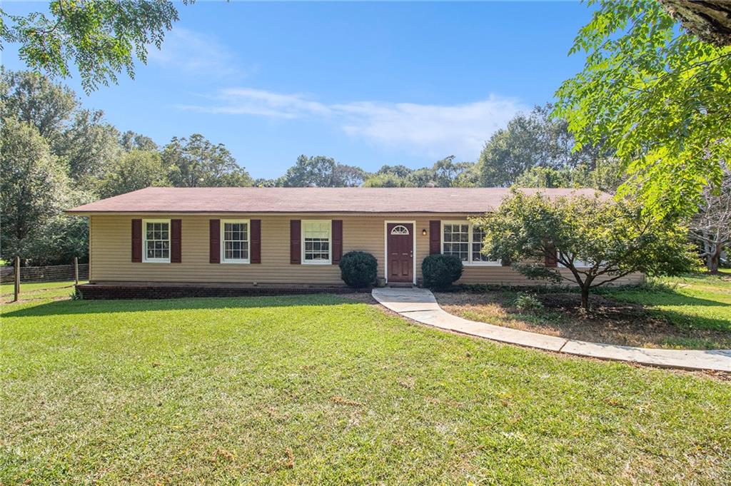 a front view of a house with a garden