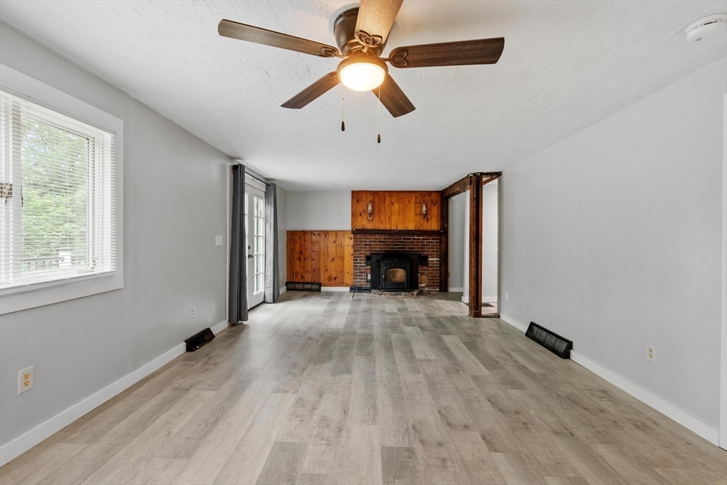 258 Allen Road Ashby, MA 01431 - Photo 13 of 36 a view of empty room with fireplace and fan