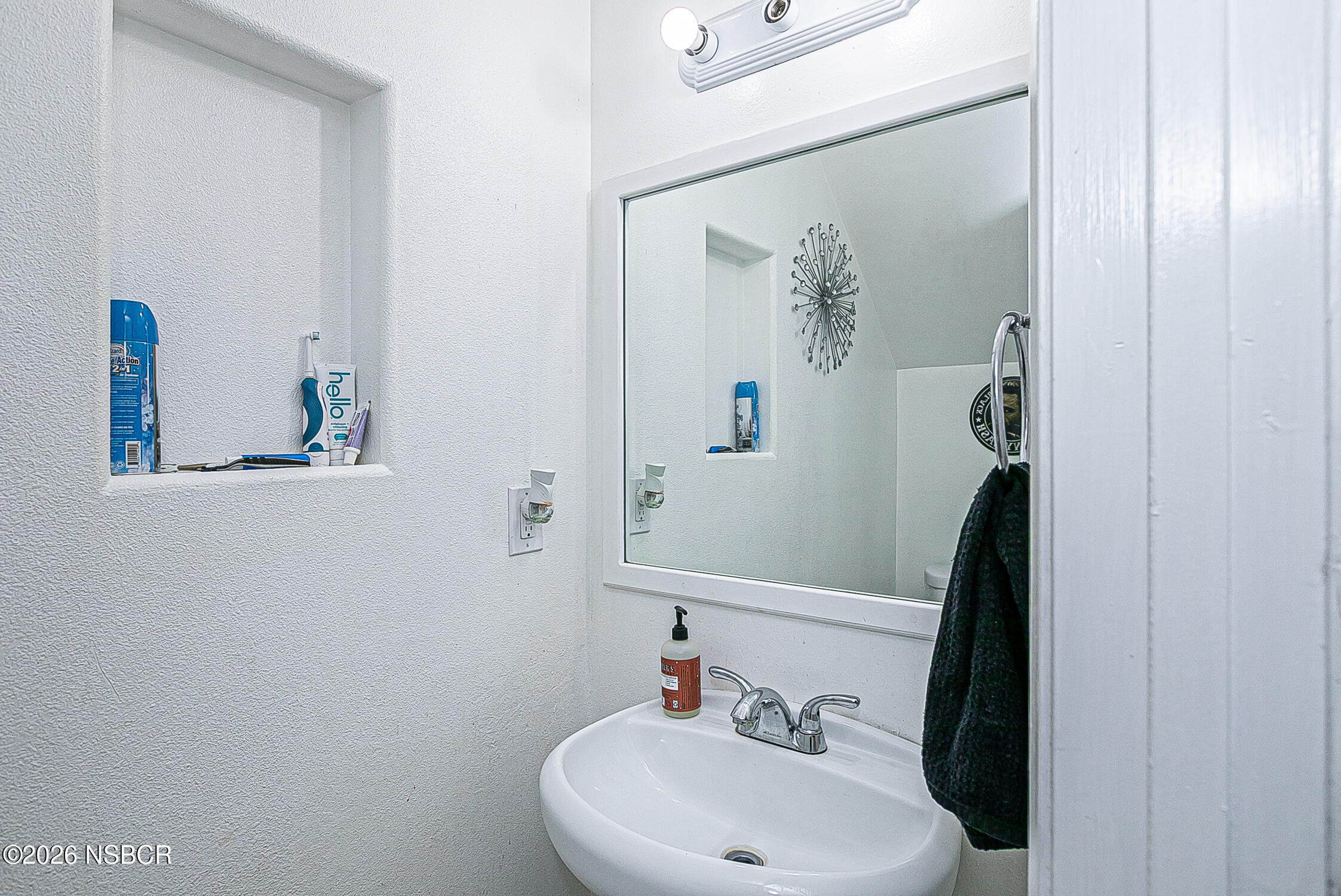 712 Pebble Beach Place Santa Maria, CA 93454 - Photo 14 of 31 a bathroom with a sink and a mirror