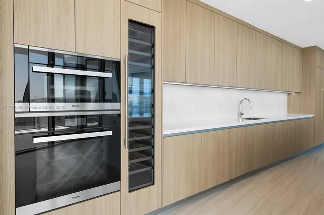 a kitchen with stainless steel appliances and cabinets